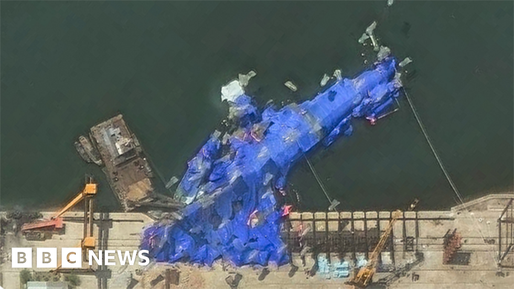 North Korea detains three officials over warship launch accident, state media says