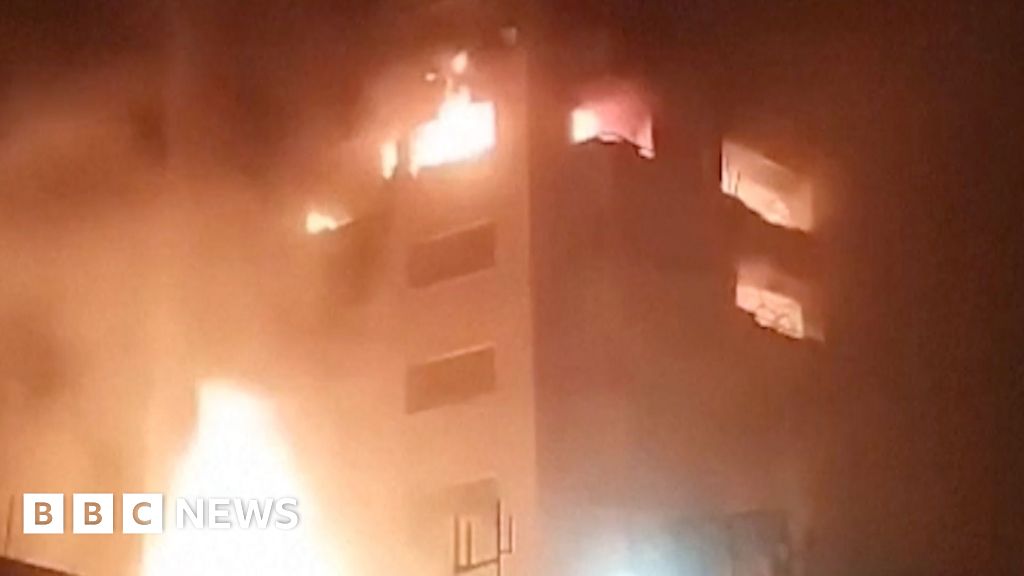Footage shows explosions and buildings ablaze in Tehran, Iran